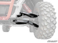 Close-up of a Polaris RZR 4 900 2 Forward Offset Boxed A-Arms, featuring large knobby tire, red coil-over shock, and black SuperATV branded arms. Faded background emphasizes suspension; SuperATV logo appears in the bottom right corner.