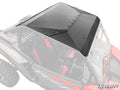 A Polaris RZR XP Aluminum Roof in matte black is shown from above on a two-seat off-road vehicle with red and black bucket seats, highlighting the roof’s riveted edges. The body and interior are partially transparent in the image.
