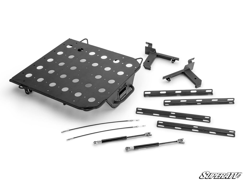 The Polaris RZR XP Cargo Rack Alpha is shown disassembled, with its black, perforated metal rack, mounting brackets, support bars, two cables, and two gas struts neatly arranged on a white background featuring the SuperATV logo.