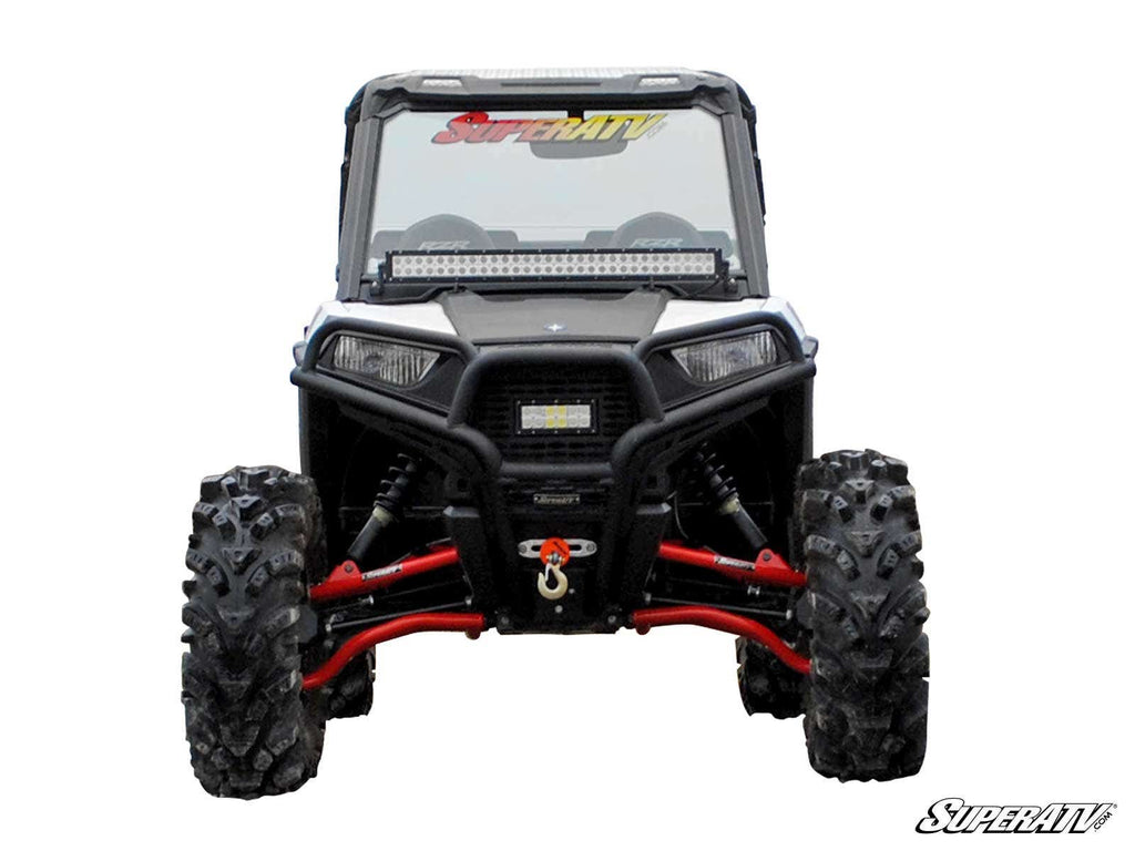 A Polaris RZR Trail 900 with the Trail S 900 Conversion Kit 1.5 Offset is shown from the front, featuring large knobby tires, red suspension parts, a winch, and a windshield labeled “SuperATV.” The SuperATV logo is in the bottom right on a white backgroun
