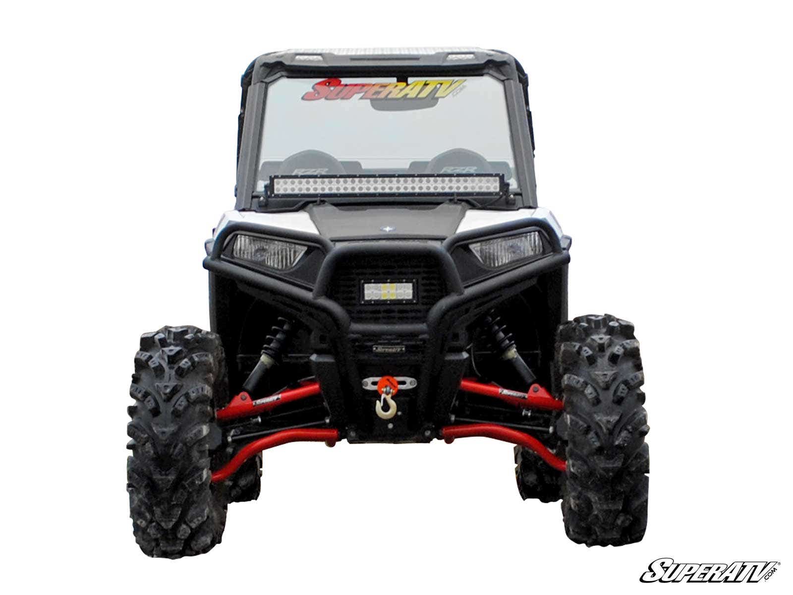 A Polaris RZR Trail 900 with the Trail S 900 Conversion Kit 1.5 Offset is shown from the front, featuring large knobby tires, red suspension parts, a winch, and a windshield labeled “SuperATV.” The SuperATV logo is in the bottom right on a white backgroun