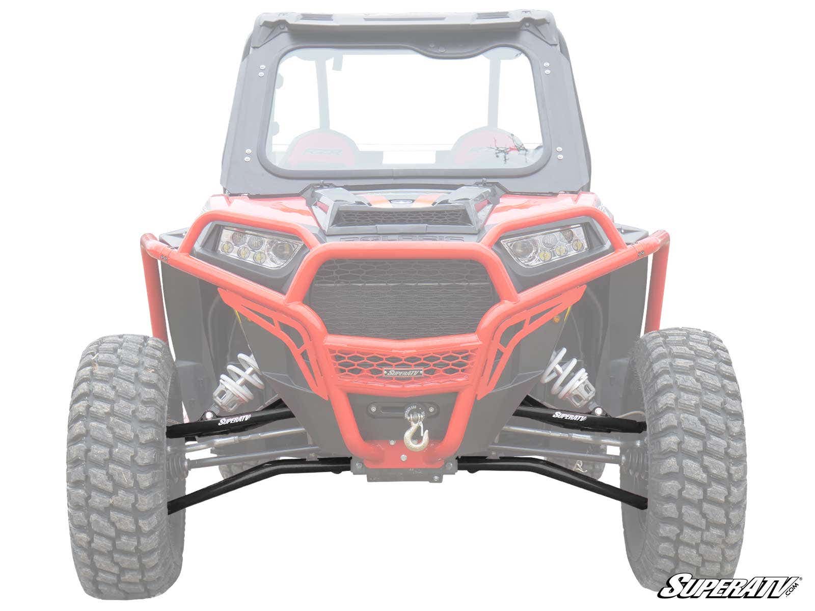 A front view of a red off-road vehicle showcases its large rugged tires, front winch, and reinforced Polaris RZR XP Turbo High-Clearance A-Arms. The suspension stands out while the rest is faded. SuperATV logo appears in the lower-right corner.