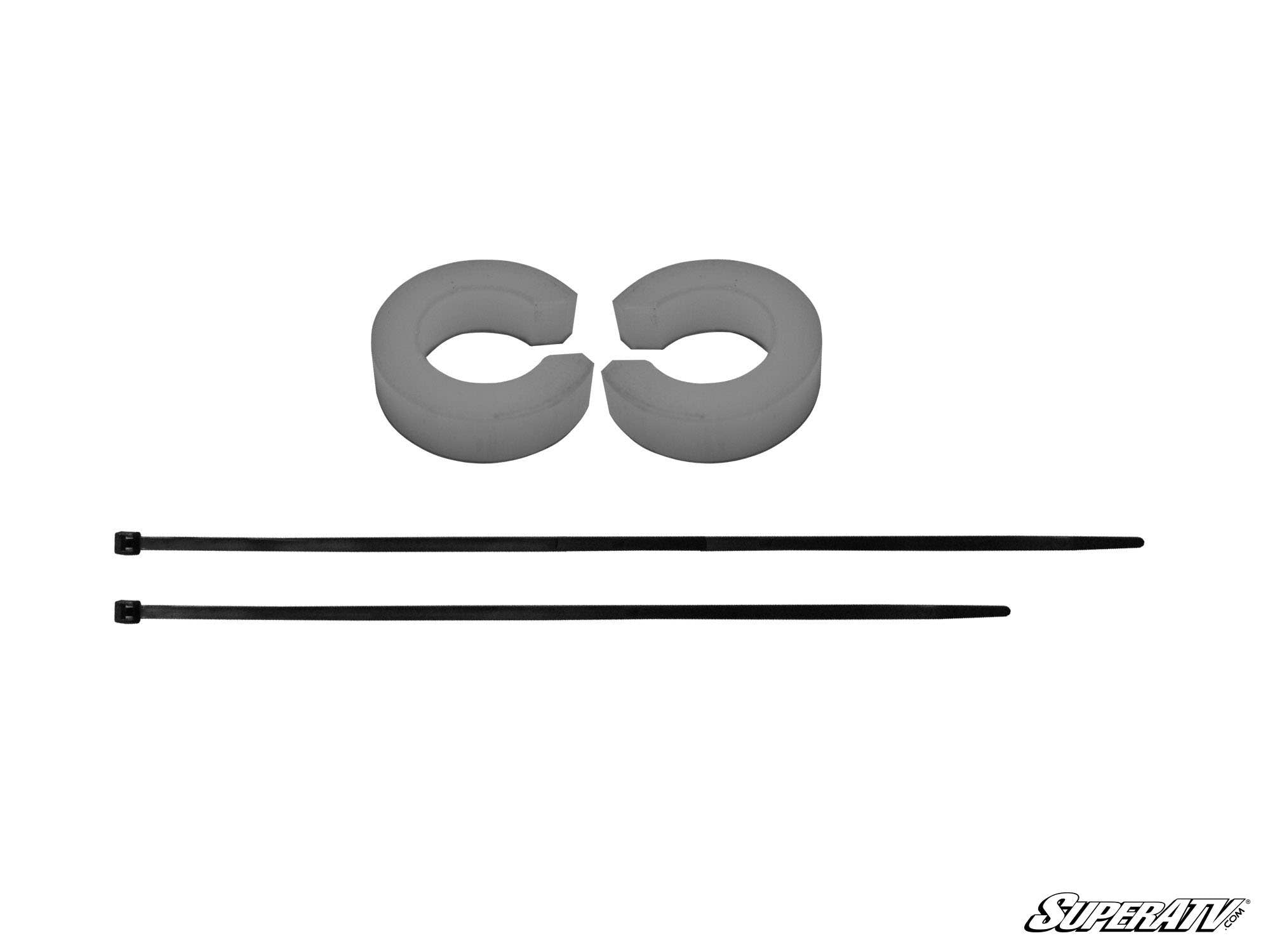 Two gray foam rings with single cuts are placed side by side above two long black zip ties on a white background, with the SuperATV logo in the lower right corner. These parts are included in the Polaris Steering Stop Kit.