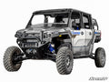 A Polaris Xpedition with a 4 Long Travel Kit, featuring blue suspension springs, large knobby tires, four doors, black roof, and side mirrors; shown on a white background with the SuperATV logo in the bottom right corner.