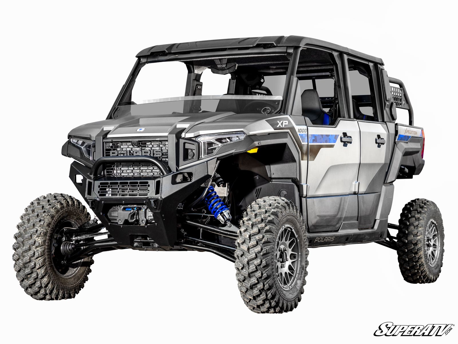 A Polaris Xpedition with a 4 Long Travel Kit, featuring blue suspension springs, large knobby tires, four doors, black roof, and side mirrors; shown on a white background with the SuperATV logo in the bottom right corner.