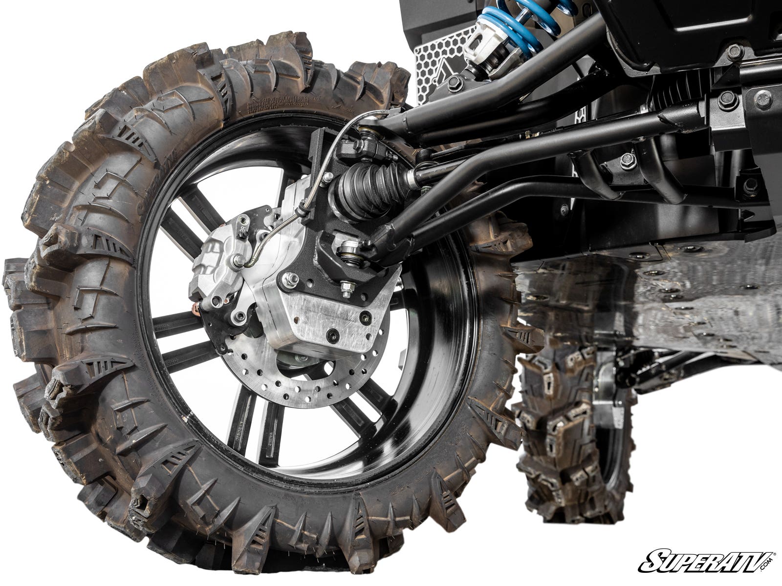 Close-up of a Polaris Xpedition 6 Portal Gear Lift showing a rugged off-road vehicles suspension, large aggressive-tread tire, visible disc brake, drivetrain, and exposed suspension components. The SuperATV logo appears in the bottom right corner.