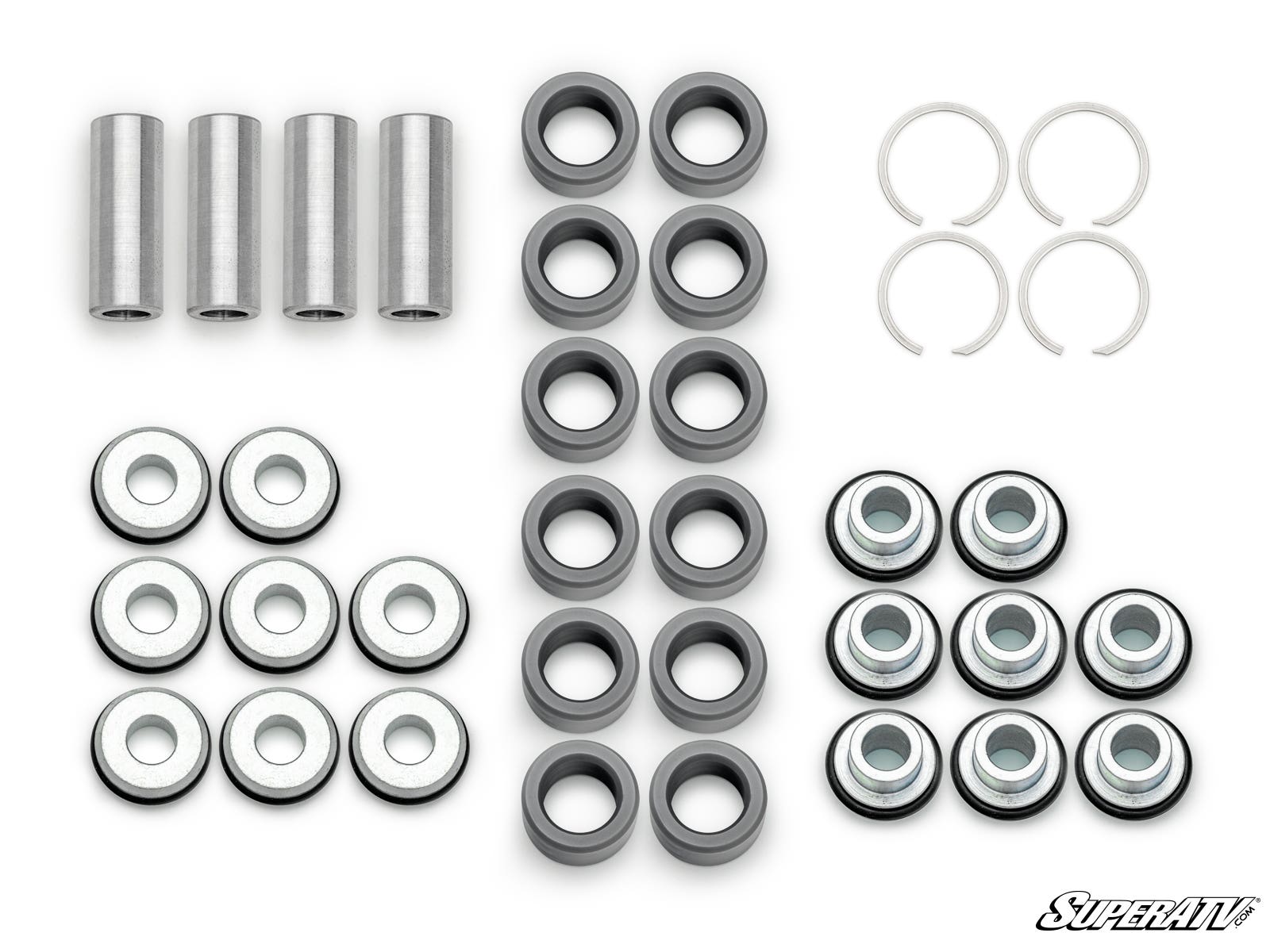 Polaris Xpedition A-Arm Bushings kit displayed on a white background: includes cylindrical spacers, flat washers, circular bushings, and four snap rings arranged by type. SuperATV logo appears in the bottom right corner.