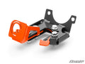 A black and orange metal Polaris Xpedition Brake Lock with bolts and a left-side circular cutout, featuring angled arms, multiple mounting holes, and photographed on white. The SuperATV logo appears in the bottom right corner.