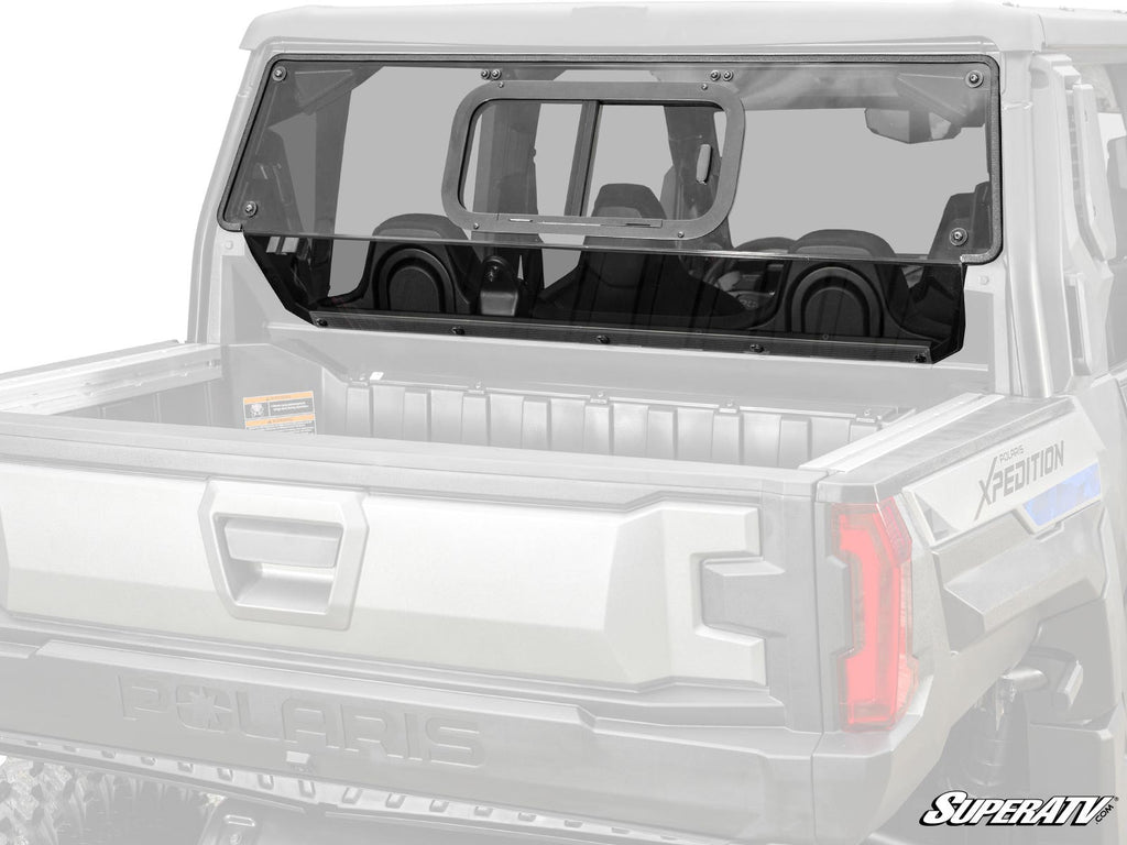 A Polaris Xpedition XP Sliding Rear Windshield, featuring clear polycarbonate and a sliding window, is installed with black hardware on the rear cab of a Polaris Xpedition. The empty truck bed and SuperATV logo are visible in the bottom right corner.