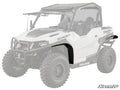 A white Polaris off-road side-by-side with rugged tires features its front left fender highlighted in black to showcase the Polaris General Low Profile Fender Flares. The vehicle is faded except for the flare, with the SuperATV logo at the lower right.