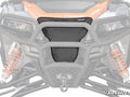 Close-up of a Polaris General Grille Cover featuring a black mesh design, orange suspension springs, sturdy metal bumper, headlights, and a winch hook at the bottom center. The SuperATV logo appears in the lower right corner.