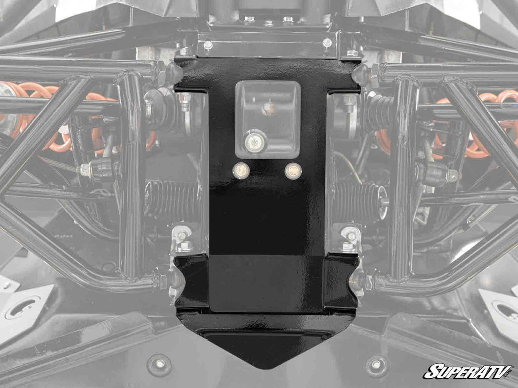 Close-up of a black Polaris General XP Frame Stiffener installed on an off-road vehicle’s undercarriage, showing suspension springs and structural components; SuperATV logo is visible in the bottom right corner.