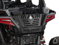 Close-up of the rear of a black Polaris RZR Turbo R with an Assault Industries Bed Enclosure, featuring red taillights, Polaris branding, and a vented, angular tailgate design. The white background highlights its rugged features and bold style.