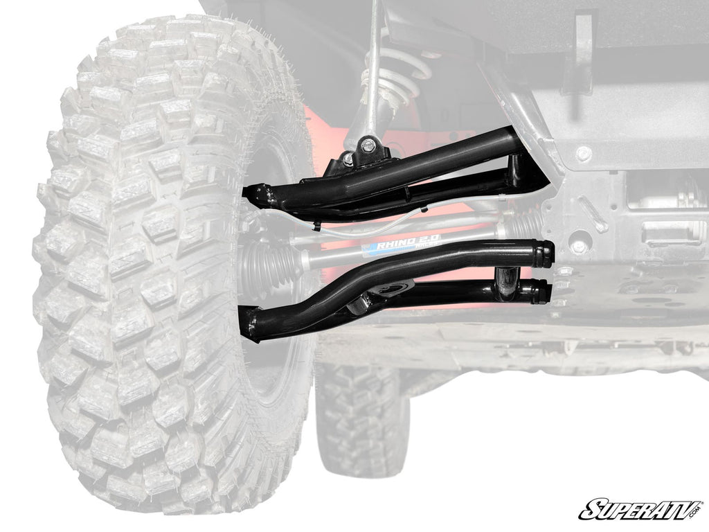 A close-up highlights Polaris Ranger 1000 Atlas Pro 1.5 Forward Offset A-Arms in black, attached to a rugged tire. The rest of the vehicle is faded, drawing focus to the new A-arms with SuperATV branding visible in the corner.