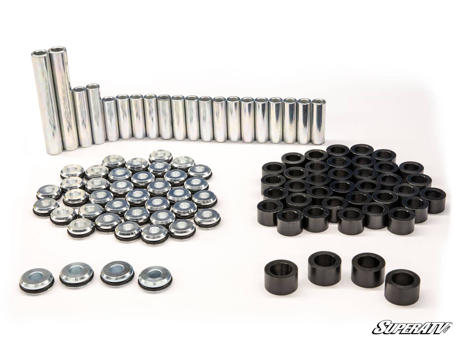 A neatly arranged set of Bobcat UV34 A-Arm Bushings, spacers, washers, and black cylindrical components displayed on a white background with the SuperATV logo in the lower right corner. Items are grouped by type and size.