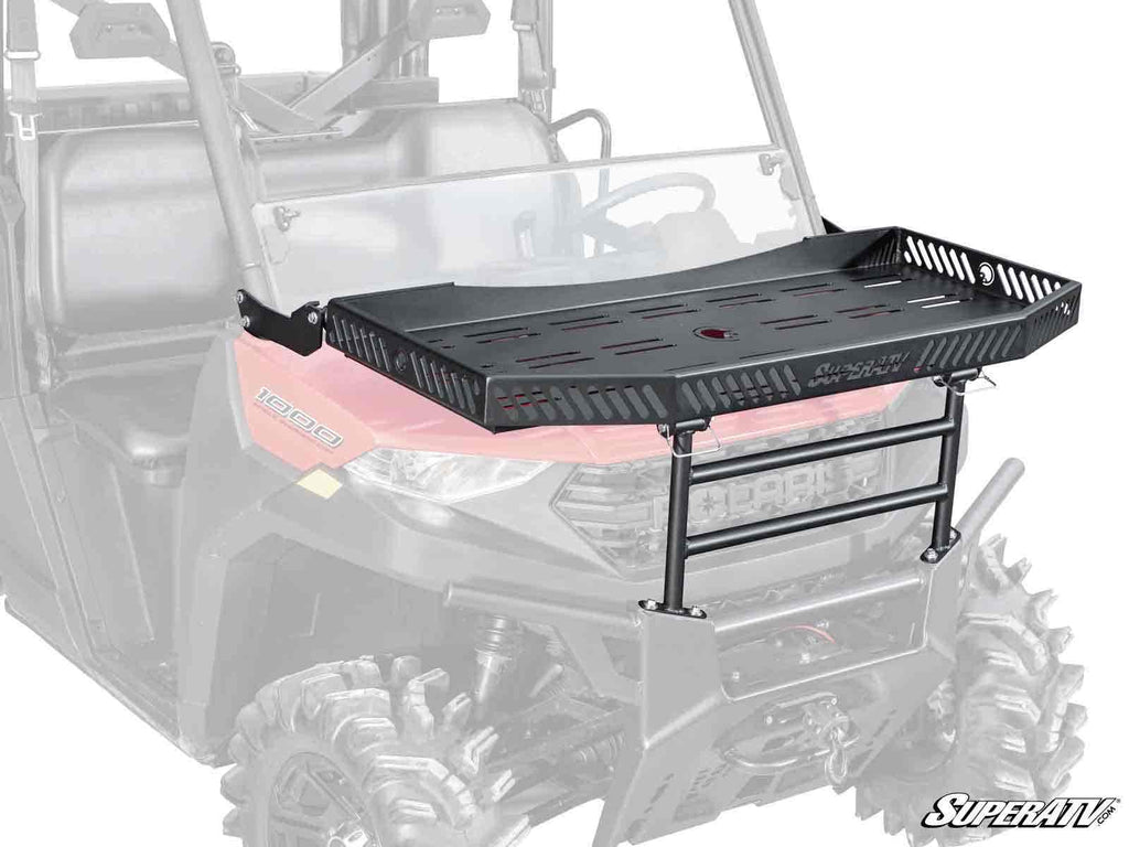 The Polaris Ranger XP Kinetic Hood Rack Charlie, a black metal rack with side rails and a grated platform, is mounted on the front hood of a red ATV. The faded background highlights the rack, with the SuperATV logo in the bottom right corner.