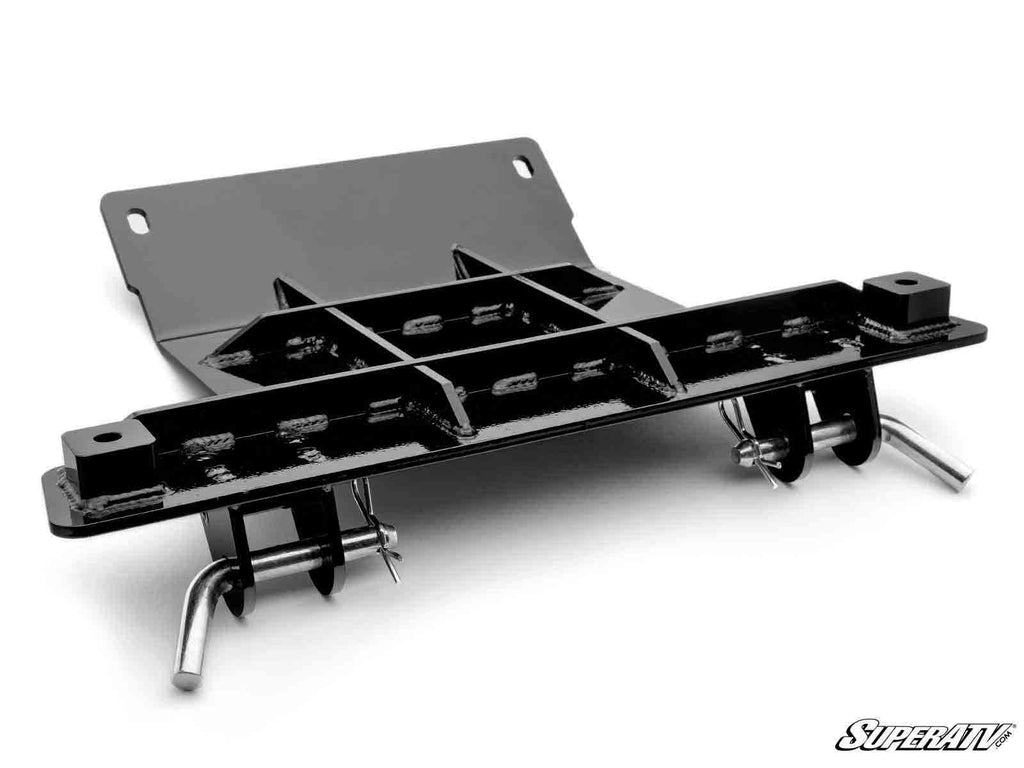 The Polaris Ranger XP 900 Plow Pro Snow Plow Mount is a black metal mount with welded reinforcement ribs, two large mounting holes, and two attached steel pins. The SuperATV logo appears in the bottom right on a white background.