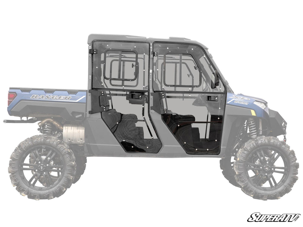 A blue Polaris Ranger XP 1000 Crew with Convertible Cab Enclosure Doors features black, full-cab clear doors and windows, detailed for fit and transparency. The lifted off-road vehicle has large rugged tires; SuperATV logo is at the bottom right.