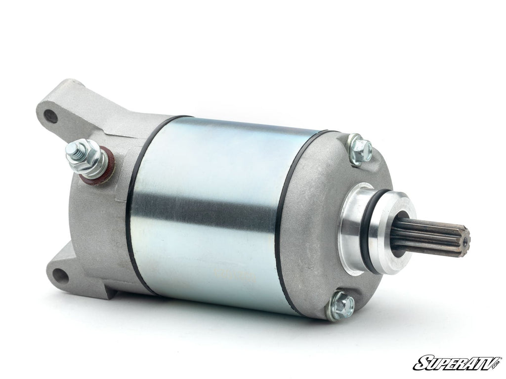 The Up & Running Polaris Pro XD Starter is a metallic electric starter motor with a cylindrical silver body, mounting flange, threaded studs, and a protruding gear shaft. The SuperATV logo appears at the bottom right on a white background.