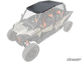 A black Polaris RZR XP 4 1000 Aluminum Roof is installed on a light gray four-seat off-road vehicle with orange seat accents, viewed from an elevated front angle. TURBO and SuperATV branding are visible.
