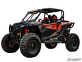 A Polaris RZR XP 1000 with a 3 Lift Kit, featuring black and orange accents, rugged tires, red coil shocks, safety bars, roof LED light bar, and graphic decals. Photographed on white with the SuperATV logo in the corner.