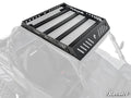 A Polaris RZR S 1000 Outfitter Sport Roof Rack with slotted black metal side panels and a SuperATV logo is mounted atop a Polaris RZR. Its rugged, heavy-duty design is ideal for cargo; the vehicle and background are faded for emphasis.
