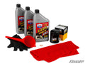 The Up & Running Polaris ACE Oil Change Kit includes three bottles of Lucas SxS/UTV engine oil, two WIX oil filters, a red funnel, black gloves, a copper washer, and a SuperATV towel arranged on a white background with the SuperATV logo.