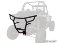 A Polaris RZR XP Turbo Rear Bumper in black, with angular lines and mounting brackets, is shown in full color over a faded off-road UTV image. The SuperATV logo appears in the bottom right corner, highlighting its protective design.