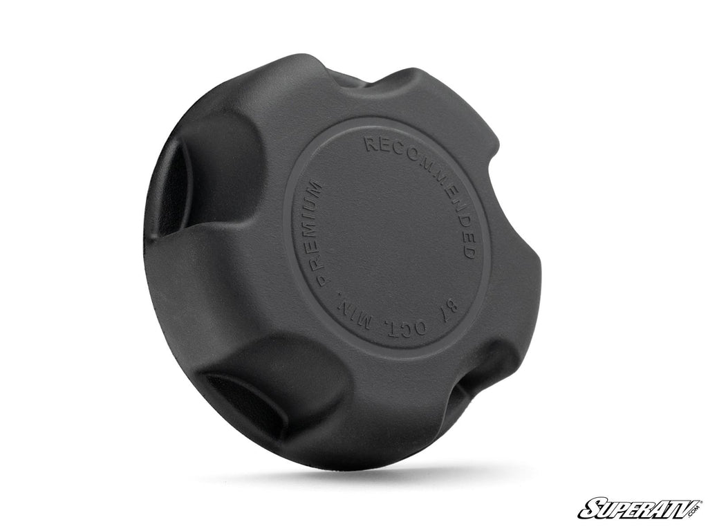 A black, round plastic Up & Running Polaris ATV/UTV Gas Cap with textured grip edges. Embossed text reads “PREMIUM RECOMMENDED” and “R OCT M/T.” Plain white background with the SuperATV logo in the bottom right corner.