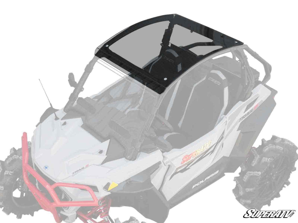 An overhead view of a white off-road vehicle with large tires showcases the Polaris RZR Trail 900 Tinted Roof, emphasizing the black-tinted polycarbonate roof while the rest of the vehicle is faded. The SuperATV logo appears in the bottom right corner.