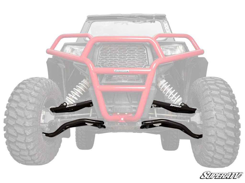 A front-facing off-road vehicle with large tires and a red brush guard showcases black Polaris RZR Trail S 1000 High Clearance A-Arms installed on the suspension. The rest of the vehicle is faded; the SuperATV logo sits in the lower right corner.