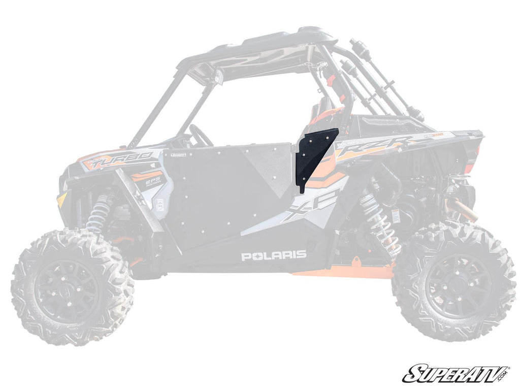 A Polaris RZR Side Panel in black metal is installed on the drivers side door of a Polaris RZR. The mostly faded vehicle emphasizes the panel, with the SuperATV logo visible in the lower right corner of the image.
