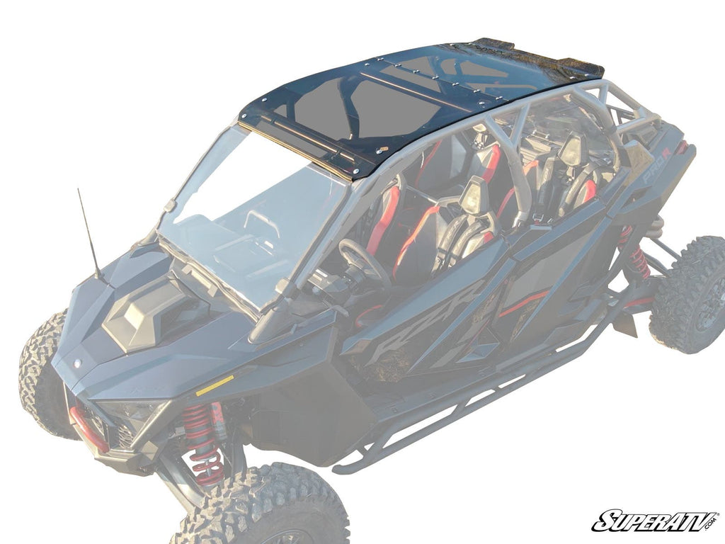 A Polaris RZR Pro R 4 with a tinted roof and windshield is shown at an angle. It has red and black seats, rugged tires, visible suspension, and a roll cage. SUPERATV branding appears in the lower right corner.