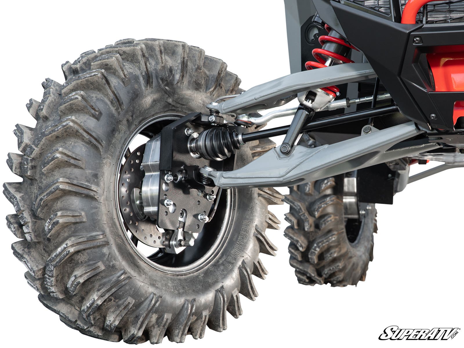 Close-up of a Polaris RZR Turbo R 6 Portal Gear Lift’s rugged suspension system and large, deeply treaded tires, showing shock absorbers, control arms, brake disc, and axle. SuperATV logo is in the bottom right corner.