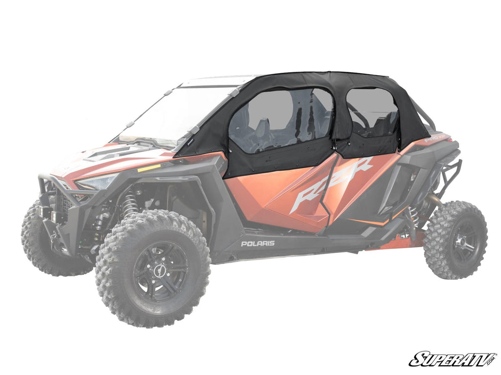 A Polaris RZR Turbo R 4 with bold red and black body, featuring RZR and POLARIS branding, is shown equipped with Primal Soft Cab Enclosure Upper Doors. Large rugged tires stand out as the background and rest of the vehicle are faded.