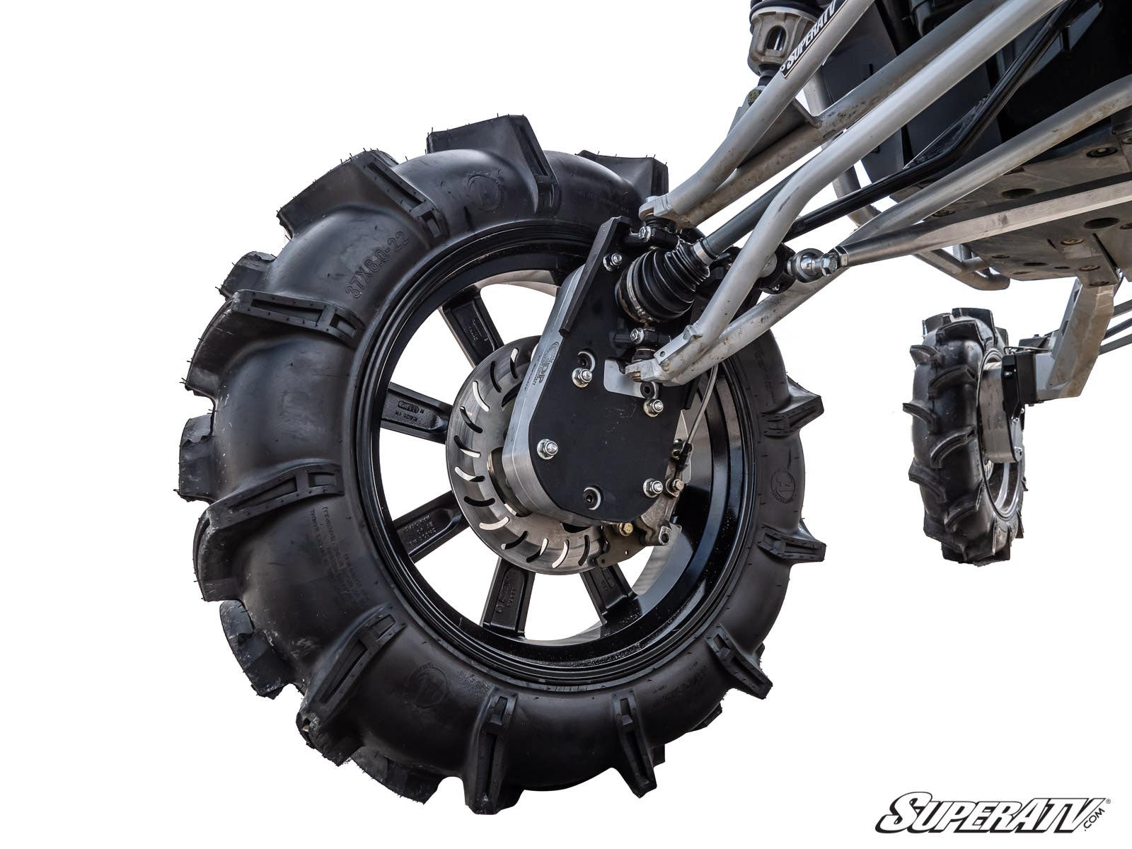 Close-up of a Polaris RZR RS1 8 Portal Gear Lift featuring a large off-road wheel with aggressive tread, black alloy rim, and visible suspension and brake components. A smaller wheel appears in the back. SuperATV logo shown on a white background.