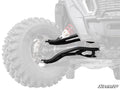 A close-up of Polaris RZR XP 1000 High Clearance 2 Forward Offset A-Arms installed on the front left wheel of an off-road vehicle with a large, deep-tread tire. The shiny A-Arms and SuperATV logo stand out against the faded background.