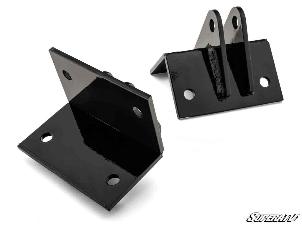 The Polaris RZR XP Plow Pro Snow Plow Mount is shown: two black metal brackets with a glossy finish, bolt holes, and angled flanges—one has upright tabs with holes, the other has flat surfaces. SuperATV logo appears in the bottom right corner.