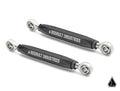 Two black metal Assault Industries Turret Rear Sway Bar End Links for Polaris RZR Pro XP with silver spherical rod ends and branding, diagonally positioned on white. Assault Industries triangular logo shown bottom right.