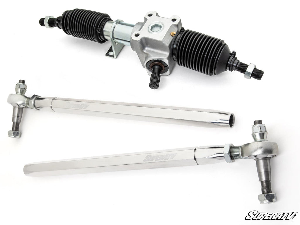 The Polaris RZR XP Turbo RackBoss 2.0 Rack and Pinion, featuring a silver assembly with black boots, is displayed above two shiny silver tie rods with joints on a clean white background, with the SuperATV logo in the corner.