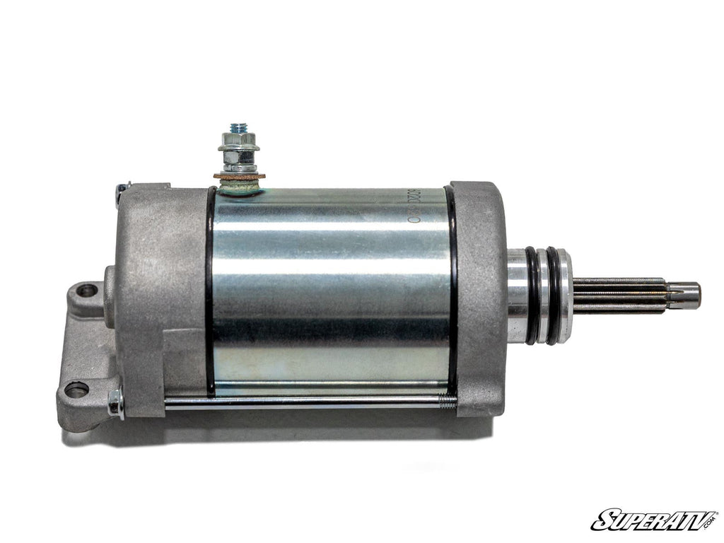 A Polaris General Starter with a metallic cylindrical body, mounting flange, bolt, and protruding shaft is shown on a white background. The SuperATV logo is in the lower right corner.