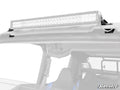 A close-up of a Polaris Xpedition 30 Light Bar Roof Mount installed on an off-road vehicle roof. Seats and roll cage are visible inside, with the SuperATV logo in the lower right. The white background highlights the light bar.