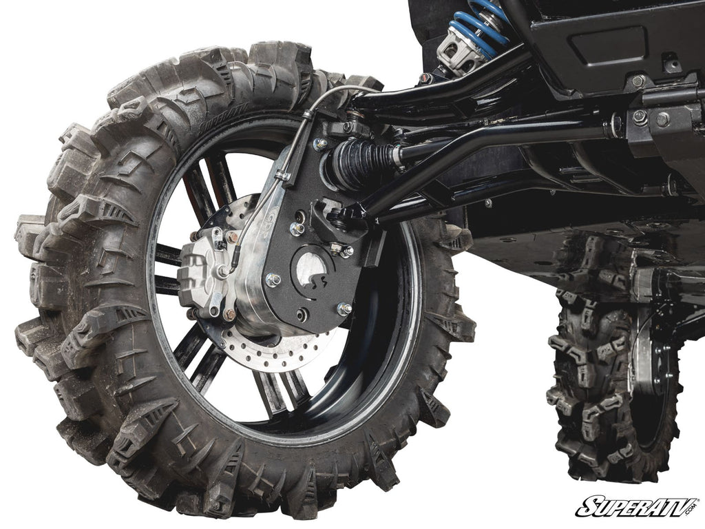 Close-up of a Polaris Xpedition 8 Portal Gear Lift installed on an off-road vehicle, showcasing its suspension, deep-tread mud tire, shock absorber, brake disc, and control arms. The SuperATV logo is visible in the bottom right corner.