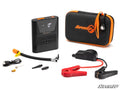 The Jump Starter with Air Compressor is a compact black and orange portable kit featuring a main battery unit with digital display, zippered carrying case, jumper cable, charging cable, air hose, valve adapters, and assorted accessories.