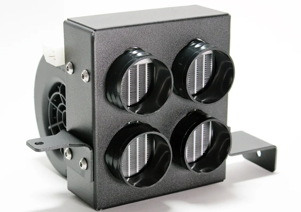 A close-up of the Inferno Cab Heater Kit With Defrost for 2019-Current Kawasaki Mule Pro Mx, featuring a black box design with four round adjustable vents with silver slats, visible side fan, and mounting brackets on a white background.