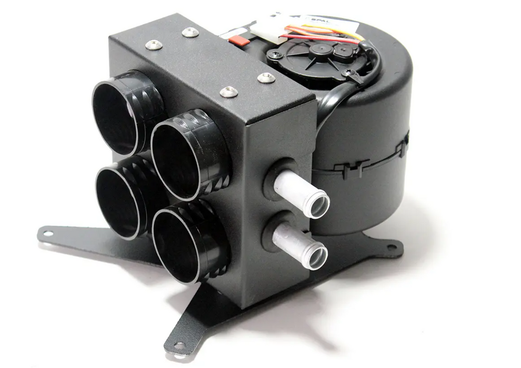The Inferno Cab Heater Kit with Defrost for 2019-current Polaris RZR XP Pro is a compact black unit with four round vents, two metal hoses, visible wiring, and a sturdy bracket, designed for vehicle climate control. Photographed on a white background.