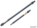Two gray metal Can-Am Defender Heavy-Duty Prop Shaft Rhino Driveline prop shafts of different lengths are side by side on a white background. Both have yokes and orange Rhino labels, with the lower shaft featuring a splined end. SuperATV logo appears at b