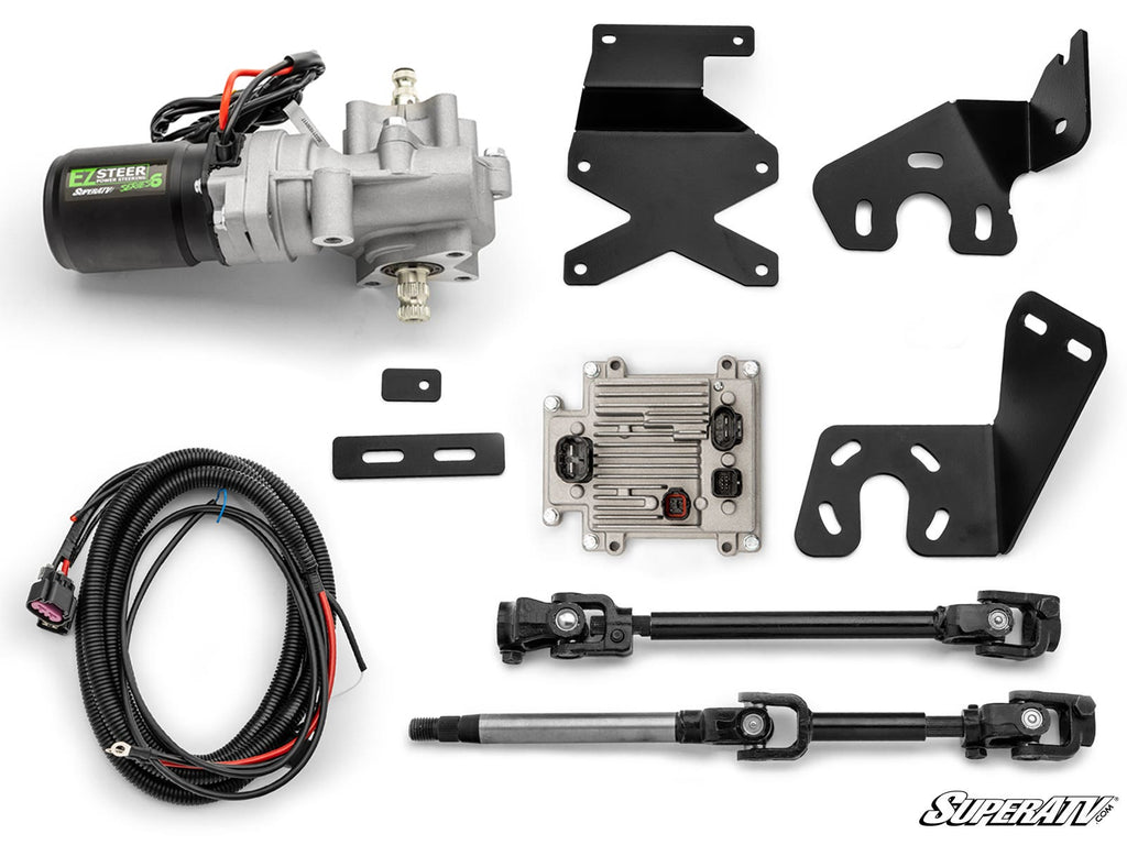 A Polaris Ranger XP Kinetic EZ-Steer Series 6 Power Steering Kit is displayed on a white background, featuring a motor, control module, wiring harness, two steering shafts, three black metal brackets, two rectangular rubber grommets, and mounting hardware