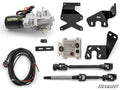 A Polaris Ranger XP Kinetic EZ-Steer Series 6 Power Steering Kit is displayed on a white background, featuring a motor, control module, wiring harness, two steering shafts, three black metal brackets, two rectangular rubber grommets, and mounting hardware