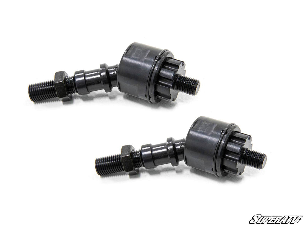 Two black, cylindrical SuperATV Inner Tie Rod End Replacements for Yamaha, featuring threaded bolts and hex nuts, are placed diagonally on a white background. The SuperATV logo is at the bottom right. The parts have a durable, machined look.